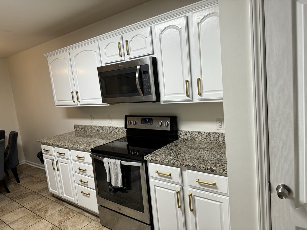 Repainted white cabinets with granite countertops